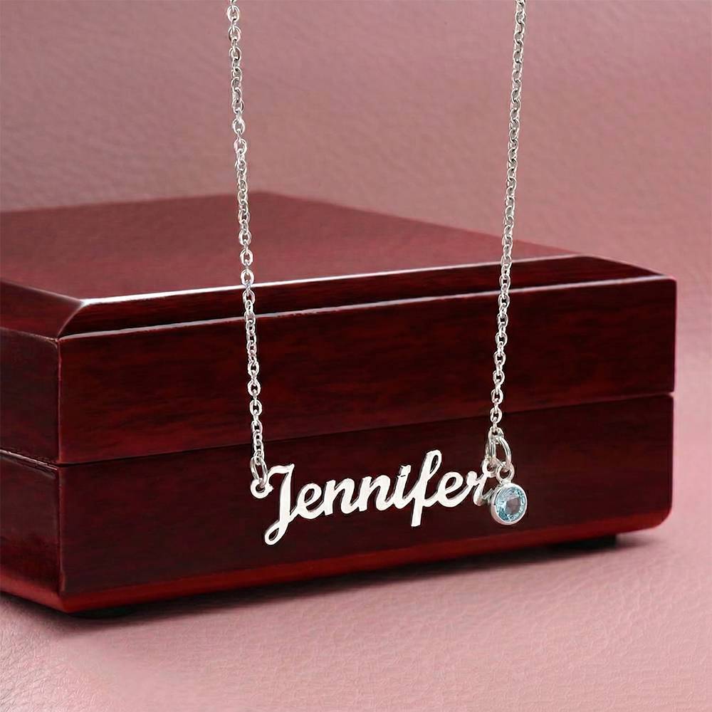 Personalized cursive name necklace in Stainless steel Polished with light blue birthstone charm, displayed on wooden jewelry box - Custom Name Necklace with Birthstone - Arkenova Jewelry